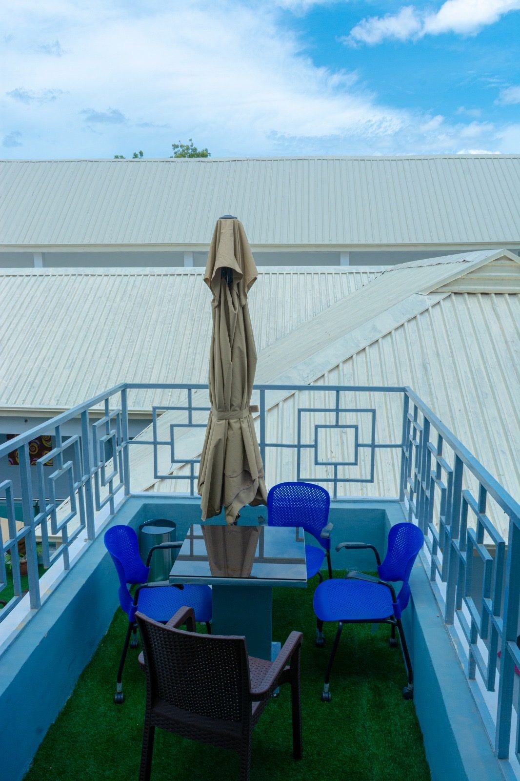 The roof terrace at House 7, looking across the pitched roofs of the compound.