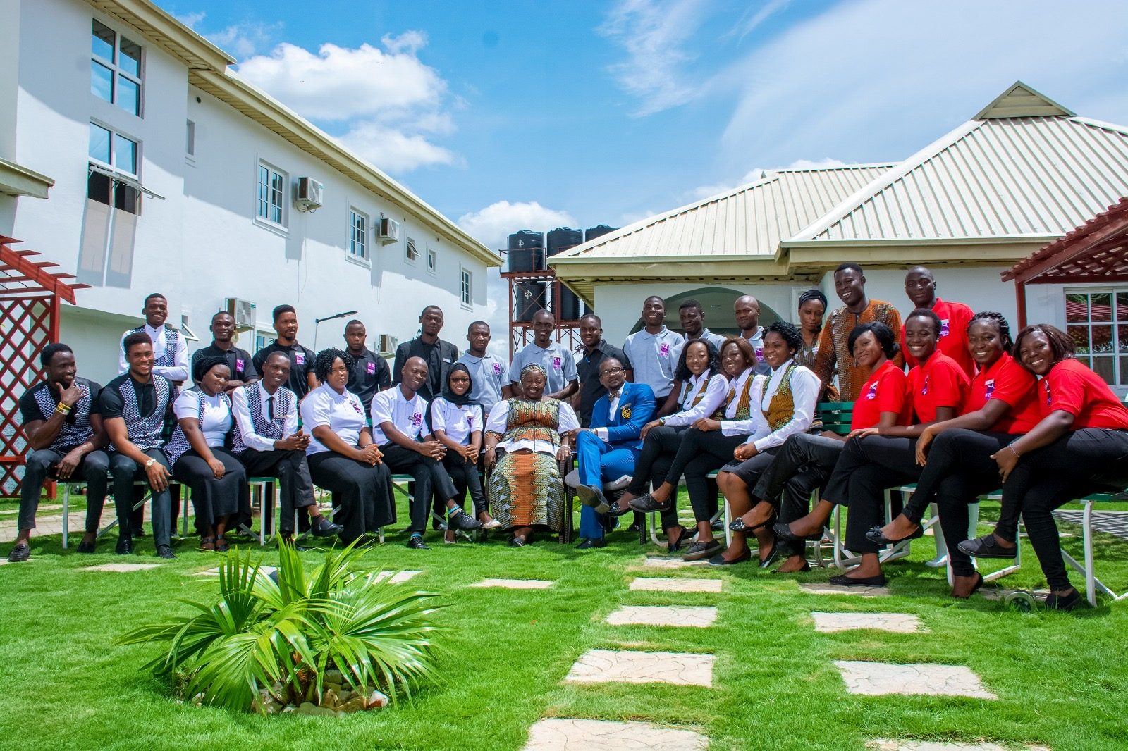 The full House 7 team seated in the courtyard.