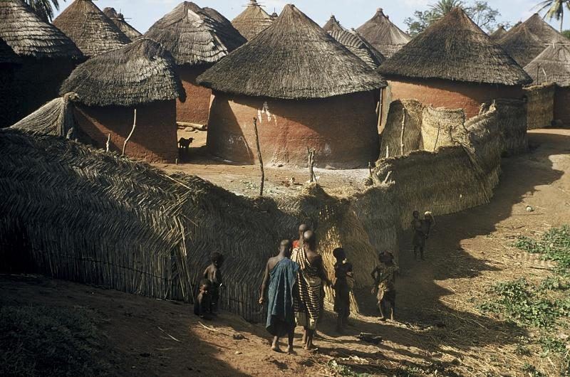 A compound of thatched granaries and mud walls outside Bida.